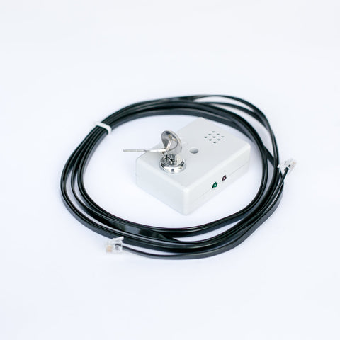 Sensormatic Key Box Sounder (Refurbished) with key inserted and connection cable