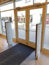 Sensormatic Dual UltraPosts Primary and Secondary (Refurbished), installed at a retail storefront entrance