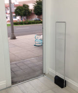 Clear Vector Retail Security Antenna (Refurbished), installed beside a store entrance doorway