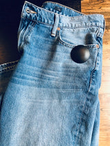Clam Tag Black (New) - Sensormatic Compatible 58KHz, attached to jeans near the pocket