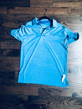 Sensormatic SuperTag II Gray - 58KHz, attached near the hem of a polo shirt