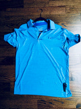 Sensormatic SuperTag II Black - 58KHz, attached near the hem of a polo shirt