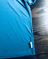 Stylus Tag Gray - Sensormatic Compatible 58KHz, attached to the hem of a blue shirt