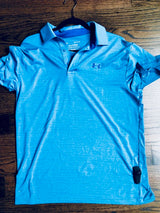 Sensormatic SuperTag III Black - 58KHz, attached to the hem of a polo shirt