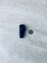 Sensormatic SuperTag III Black - 58KHz, shown next to a quarter for scale